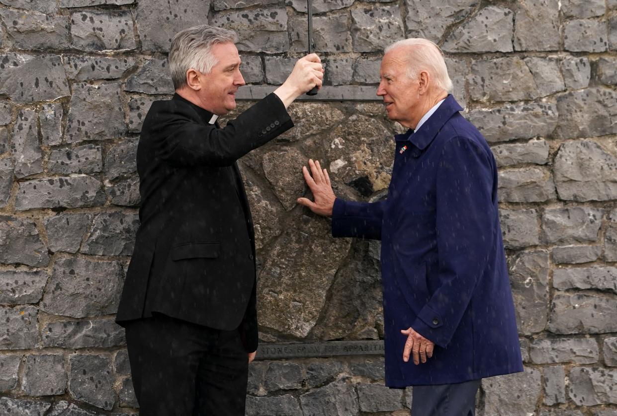 Joe Biden touches the original gable wall of the church at the Knock Shrine (REUTERS/Kevin Lamarque)