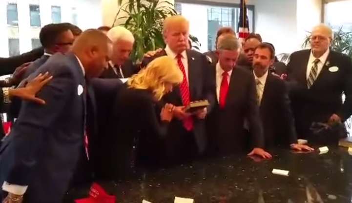 A screenshot from a video taken in September 2015, in which Paula White and a number of other prosperity preachers laid hands on Donald Trump and prayed for him at Trump Tower. (Photo: YouTube)