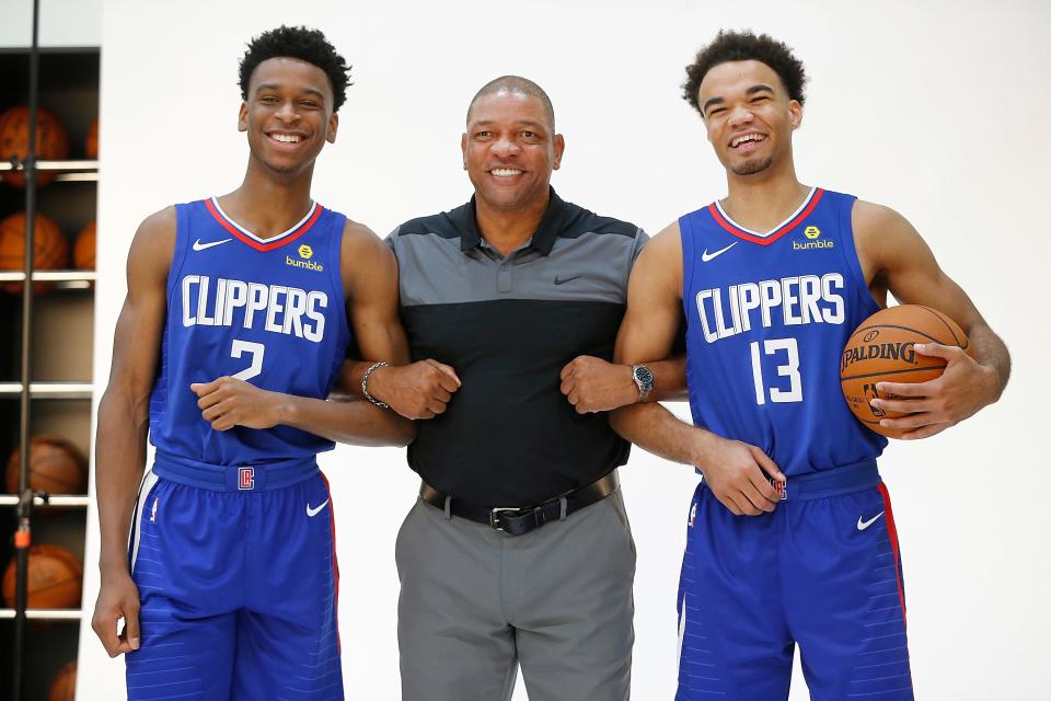 Los Angeles Clippers Head Coach Doc Rivers, middle, poses for a photos with Canadian player Shai Gilgeous-Alexander, left, and Jerome Robinson, right after they were introduced as the newest Clippers guards at the L.A. Clippers Training Center in Los Angeles on Monday, June 25, 2018. (AP Photo/Damian Dovarganes)