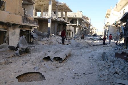 People inspect a damaged site after airstrikes on the rebel held Sheikh Fares neighbourhood of Aleppo, Syria October 1, 2016. REUTERS/Abdalrhman Ismail