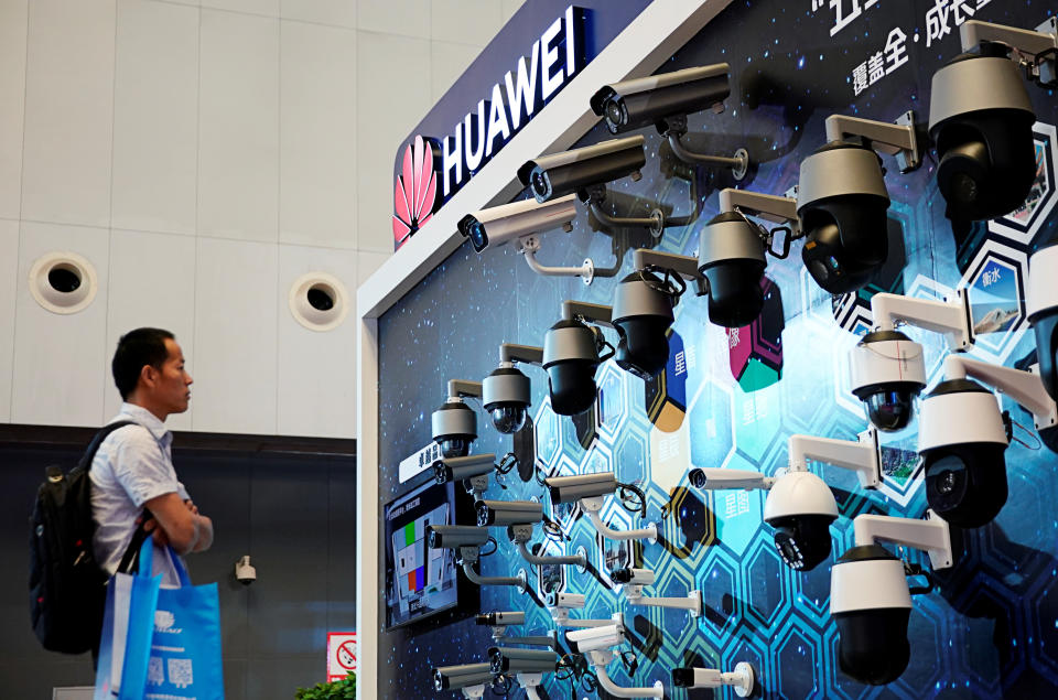 A man looks at surveillance cameras displayed at Huawei's booth at the security exhibition in Shanghai, China, May 24, 2019. REUTERS/Aly Song