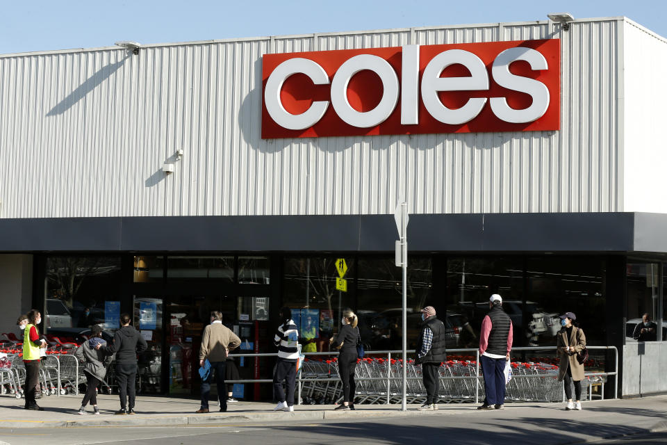 Shoppers line up outside a Coles supermarket in Malvern in Melbourne