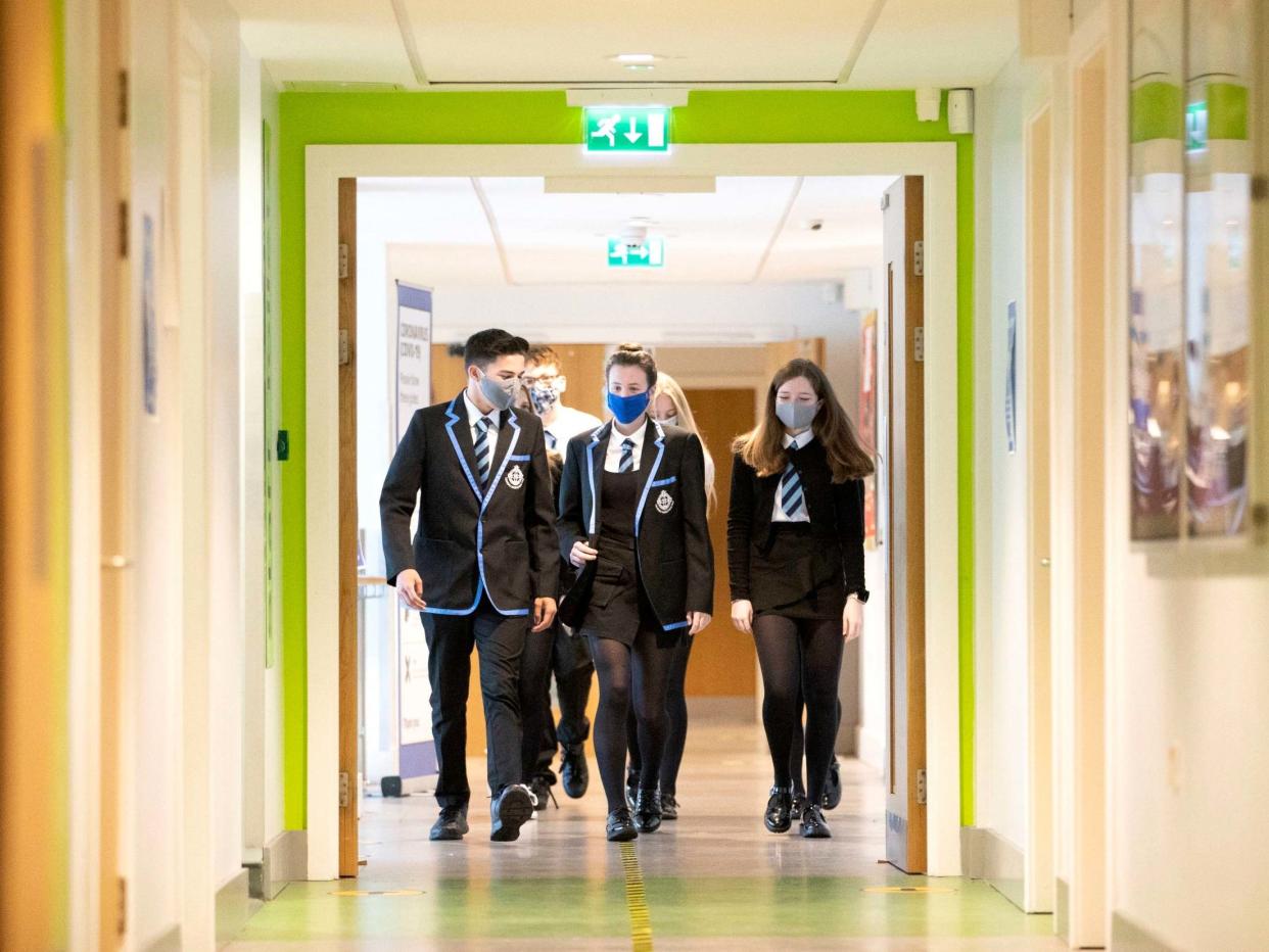 Students wear protective face masks as they head to lessons at St Columba's High School, Gourock, Scotland, 31 August 2020: PA