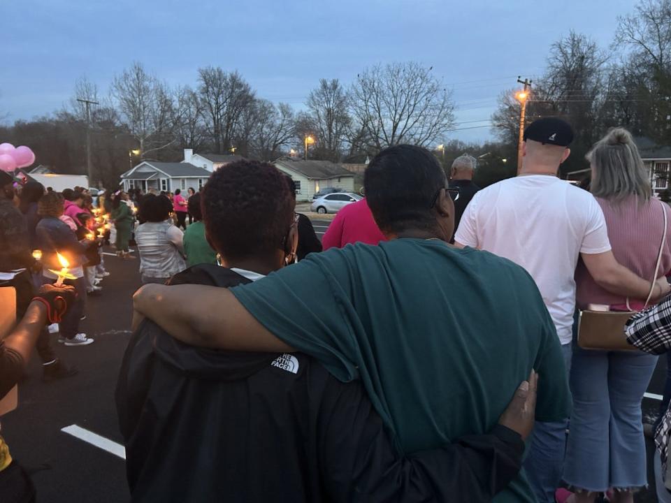 Participants in a candlelight vigil for P'aris Moore hold on to each other for comfort Tuesday, Jan. 3, 2023 in Hopewell. P'aris is the eight-year-old girl who was killed Dec. 30 in what police believe was a drive-by shooting. Tuesday would have been her ninth birthday.