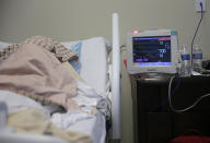 A COVID-19 patient lies at DHR Health, Wednesday, July 29, 2020, in McAllen, Texas. At DHR Health, the largest hospital on the border, roughly half of the 500 beds belong to coronavirus patients isolated in two units. A third unit is in the works. (AP Photo/Eric Gay)