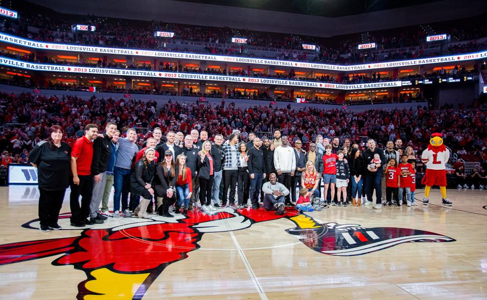 Players, coaches, trainers and their loved ones gathered at midcourt as the Louisville Cardinals 2013 National Championship squad was honoroed during halftime of Louisville's game against Clemson at the KFC Yum Center on Saturday evening. Feb. 18, 2023