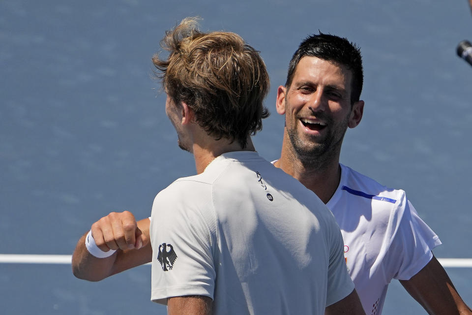 Novak Djokovic, of Serbia, right, talks with Alexander Zverev, of Germany after their practice for the men's tennis competition at the 2020 Summer Olympics, Thursday, July 22, 2021, in Tokyo. (AP Photo/Charlie Riedel)