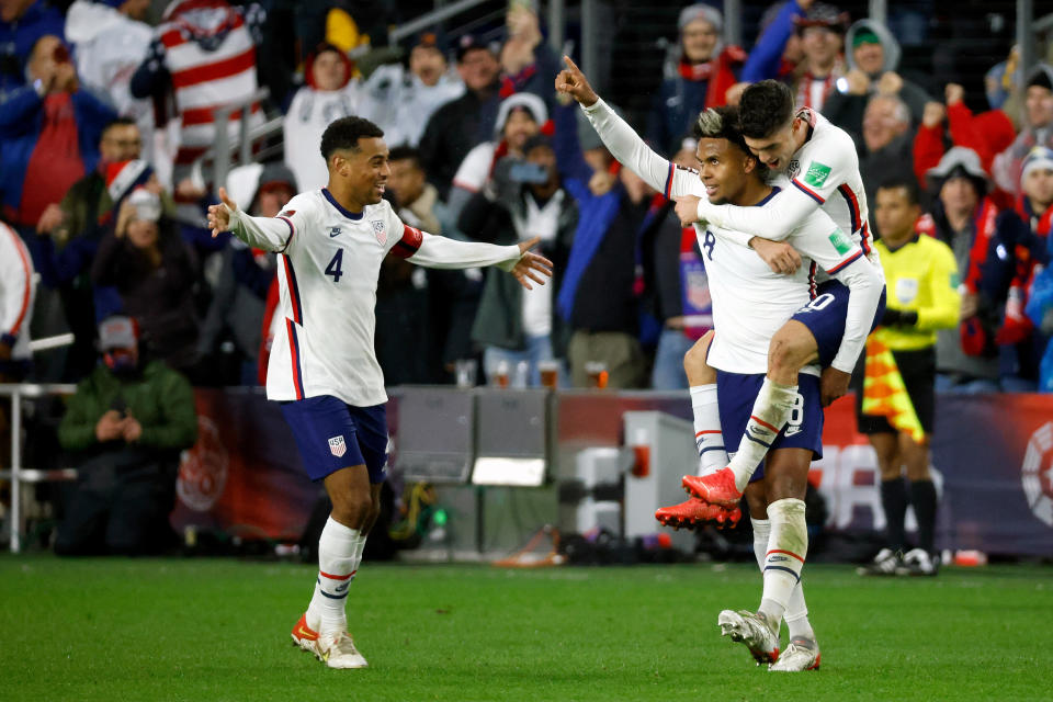 CINCINNATI, OH - NOVEMBER 12:  Weston McKennie #8 of the United States is congratulated by Christian Pulisic #10 and Tyler Adams #4 after scoring a goal during the second half of the FIFA World Cup 2022 Qualifier match against Mexico at TQL Stadium on November 12, 2021 in Cincinnati, Ohio. The United States defeated Mexico 2-0.(Photo by Kirk Irwin/Getty Images)