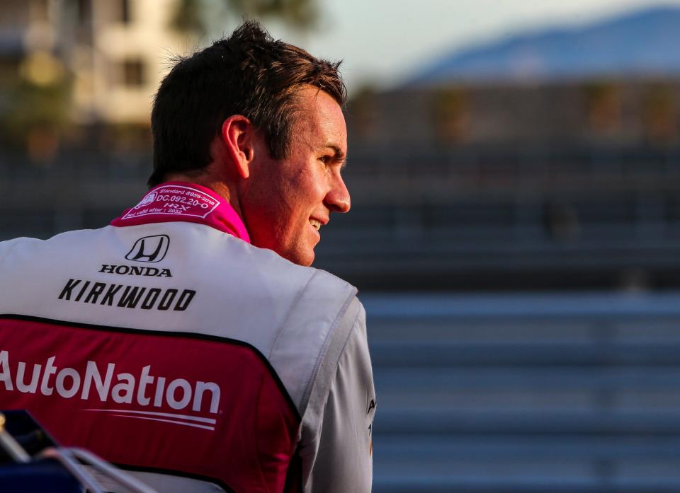 Kyle Kirkwood of Andretti Autosport smiles at a crew member after finishing the evening session during day one of NTT IndyCar Series open testing at The Thermal Club in Thermal, Calif., Thursday, Feb. 2, 2023.