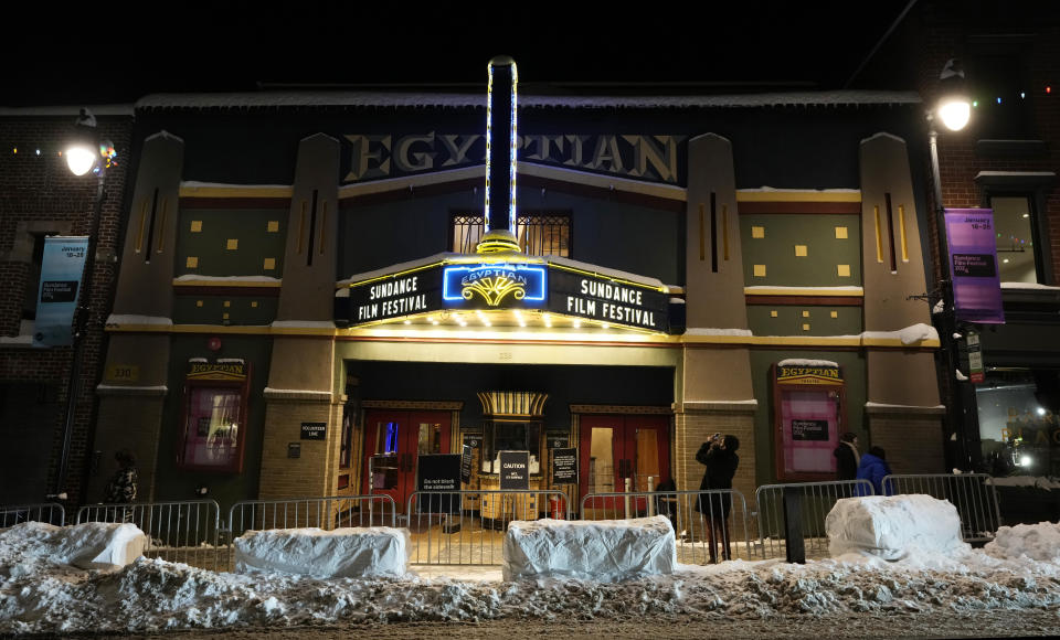 A man takes a picture of the marquee of the Egyptian Theatre before the start of the Sundance Film Festival, Wednesday, Jan. 17, 2024, in Park City, Utah. The Sundance Film Festival runs from Jan. 18-28 at venues around Park City and Salt Lake City, Utah. (AP Photo/Chris Pizzello)