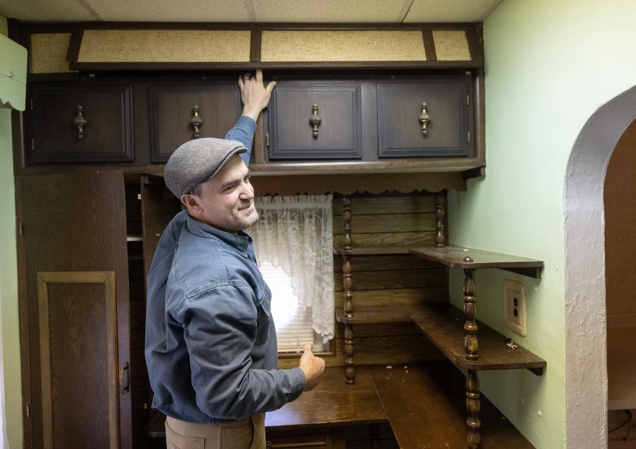 Joe Karam, home preservation manager for Habitat for Humanity East Central Ohio, points to the hidden compartment where the Johnson family home heirlooms and photos were found.