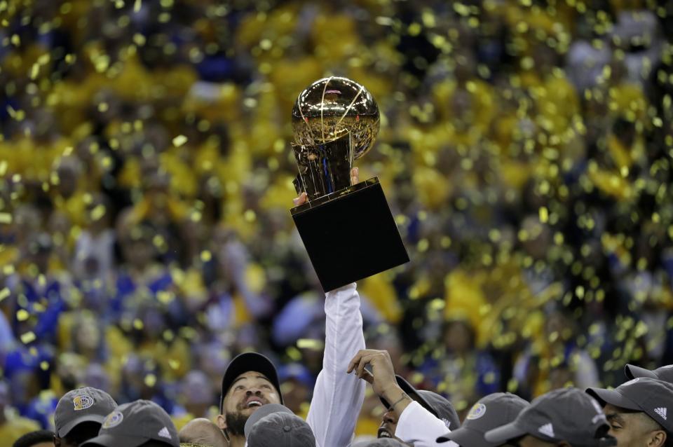 <p>Golden State Warriors center JaVale McGee holds up the Larry O’Brien NBA Championship Trophy after Game 5 of basketball’s NBA Finals between the Warriors and the Cleveland Cavaliers in Oakland, Calif., Monday, June 12, 2017. The Warriors won 129-120 to win the NBA championship. (AP Photo/Marcio Jose Sanchez) </p>