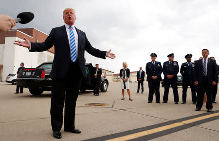 U.S. President Donald Trump speaks to the news media on the airport tarmac about the federal conviction of his former presidential campaign chairman Paul Manafort as the president arrives for a campaign event in Charleston, West Virginia, U.S. August 21, 2018. REUTERS/Leah Millis
