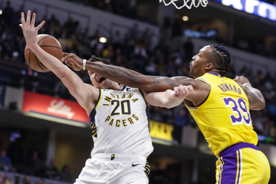 Los Angeles Lakers center Dwight Howard (39) fouls Indiana Pacers forward Doug McDermott (20) during the second half of an NBA basketball game in Indianapolis, Tuesday, Dec. 17, 2019. The Pacers defeated the Lakers 105-102. (AP Photo/Michael Conroy)