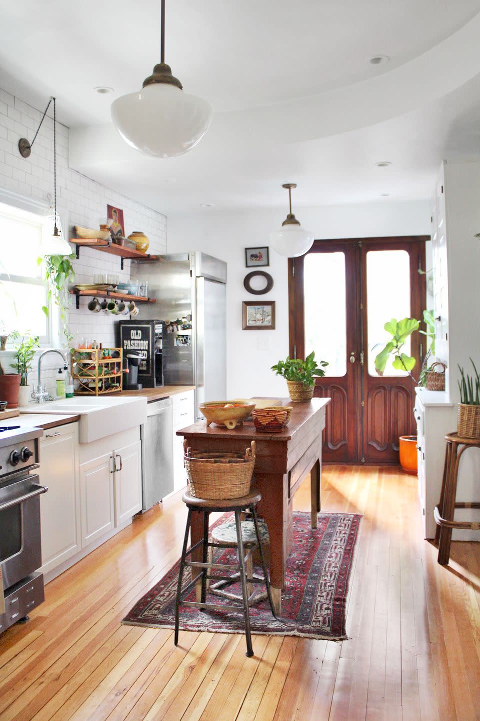 a kitchen with a bar stool and wood island