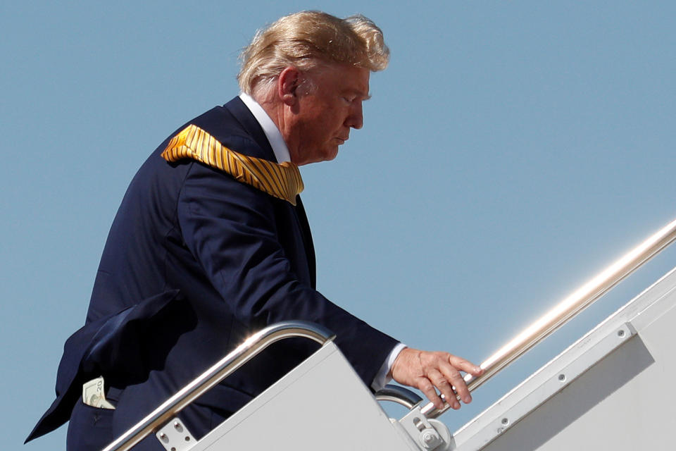 Money is seen in the back pocket of President Trump as he boards Air Force One at Moffett Federal Airfield in Mountain View, Calif., on Tuesday. (Photo: Tom Brenner/Reuters)