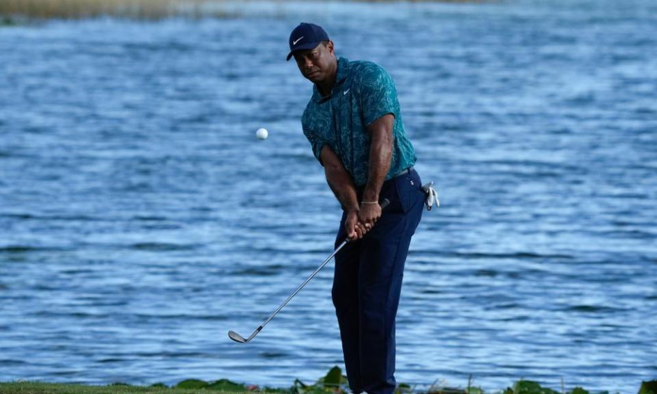 Tiger Woods lobs his ball onto the green on the 18th hole of his second round at the Hero World Challenge. 