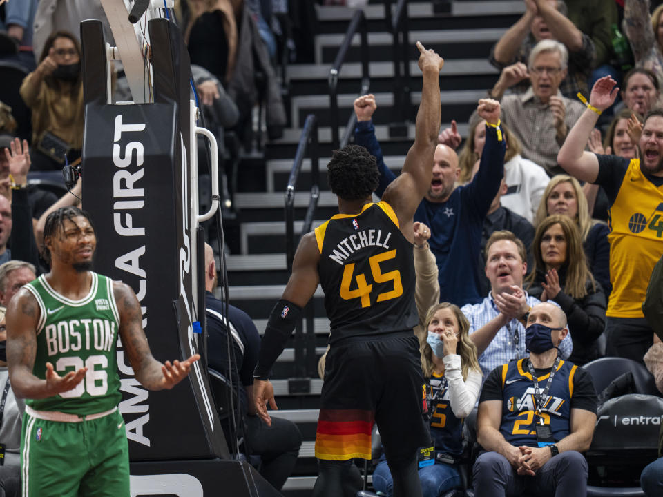 Boston Celtics guard Marcus Smart (36) reacts after being called for a foul as Utah Jazz guard Donovan Mitchell (45) celebrates his own basket in the final minutes of an NBA basketball game Friday, Dec. 3, 2021, in Salt Lake City. (AP Photo/Rick Egan)
