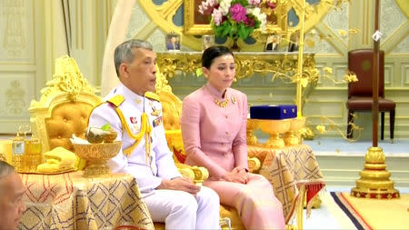 King Maha Vajiralongkorn and his consort, General Suthida Vajiralongkorn named Queen Suthida attend their wedding ceremony in Bangkok, Thailand May 1, 2019, in this screen grab taken from a video. Thai TV Pool