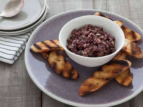<strong>Get the <a href="http://www.huffingtonpost.com/2011/10/27/olive-and-garlic-tapenade_n_1059869.html">Olive and Garlic Tapenade Crostini recipe</a></strong>