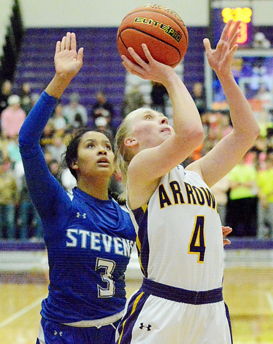 Watertown's Maddy Rohde (4) scores against Rapid City Stevens' Taaliyah Porter during a high school girls basketball during the 2021-22 season in the Watertown Civic Arena.