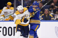 Nashville Predators center Yakov Trenin (13) and Buffalo Sabres defenseman Casey Fitzgerald (45) collide during the second period of an NHL hockey game Friday, April 1, 2022, in Buffalo, N.Y. (AP Photo/Jeffrey T. Barnes)