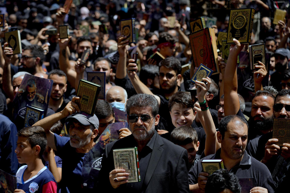 Hezbollah raise the Quran during a rally after Friday prayers in the southern Beirut suburb of Dahiyeh, Lebanon, Friday, July 21, 2023. Muslim-majority nations expressed outrage Friday at the desecration of the Islamic holy book in Sweden. Following midday prayers, thousands took to the streets to show their anger, in some cases answering the call of religious and political leaders. (AP Photo/Bilal Hussein)