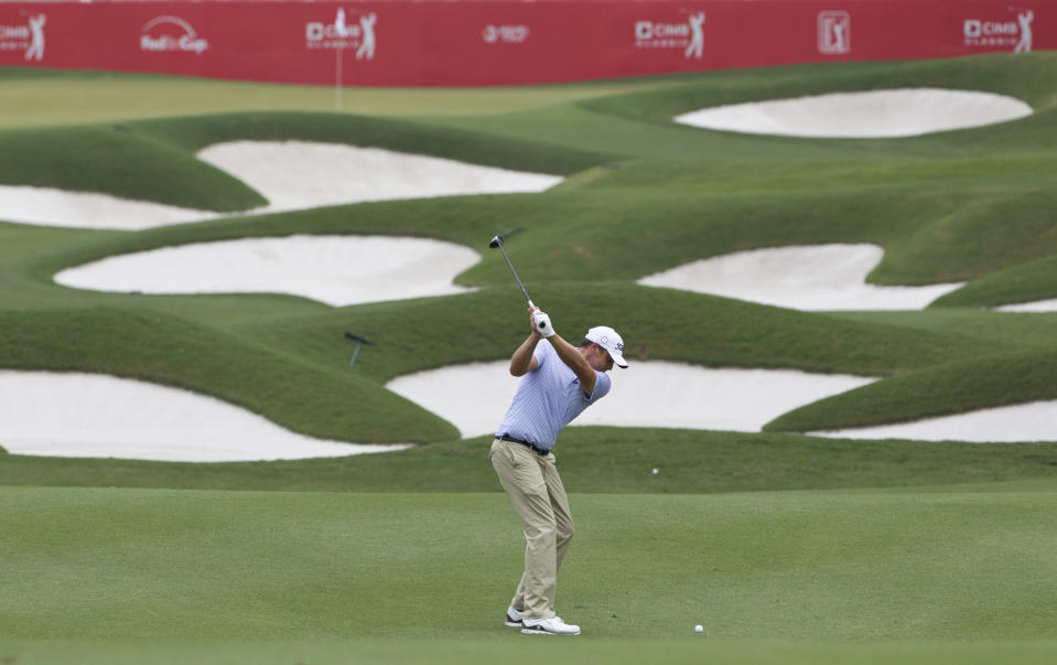 Nick Watney of the United States of America follows his shot on the eighteenth hole during round two of the CIMB Classic golf tournament at Tournament Players Club (TPC) in Kuala Lumpur, Malaysia, Friday, Oct. 12, 2018. (AP Photo/Yam G-Jun)