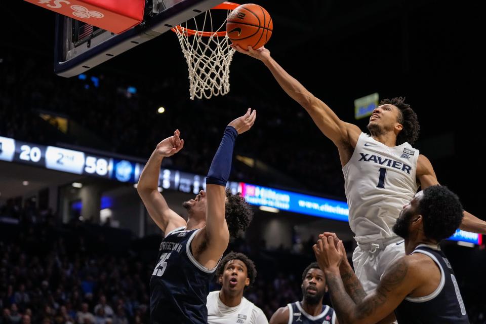 Xavier Musketeers guard Desmond Claude (1) attempts to tip back a rebound in the second half of the NCAA Big East game between the Xavier Musketeers and the Georgetown Hoyas at the Cintas Center in Cincinnati on Friday, Jan. 19, 2024. Xavier won 92-91.