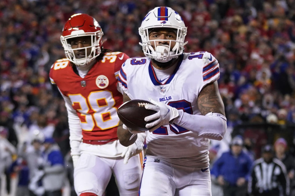 Buffalo Bills wide receiver Gabriel Davis (13) catches a 19-yard touchdown pass ahead of Kansas City Chiefs cornerback L'Jarius Sneed (38) during the second half of an NFL divisional round playoff football game, Sunday, Jan. 23, 2022, in Kansas City, Mo. (AP Photo/Ed Zurga)