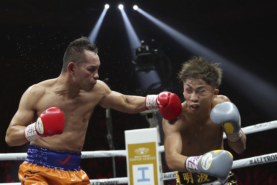 Philippines' Nonito Donaire, left, sends a left to Japan's Naoya Inoue in the fourth round of their World Boxing Super Series bantamweight final match in Saitama, Japan, Thursday, Nov. 7, 2019. Inoue beat Donaire with a unanimous decision to win the championship. (AP Photo/Toru Takahashi)