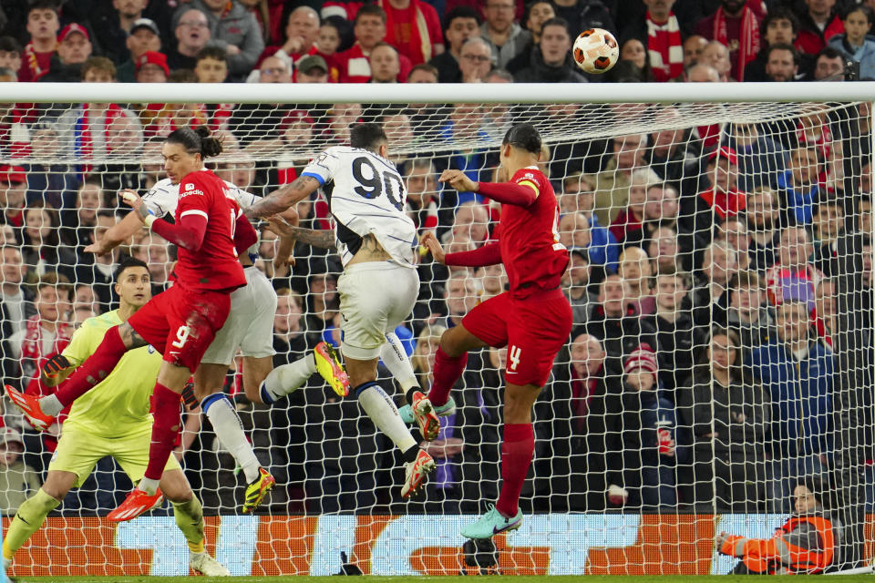 Liverpool's Darwin Nunez, left, and Virgil van Dijk and Atalanta's Gianluca Scamacca jump for the ball during the Europa League quarter final first leg soccer match between Liverpool and Atalanta, at the Anfield stadium in Liverpool, England, Thursday, April 11, 2024. (AP Photo/Jon Super)