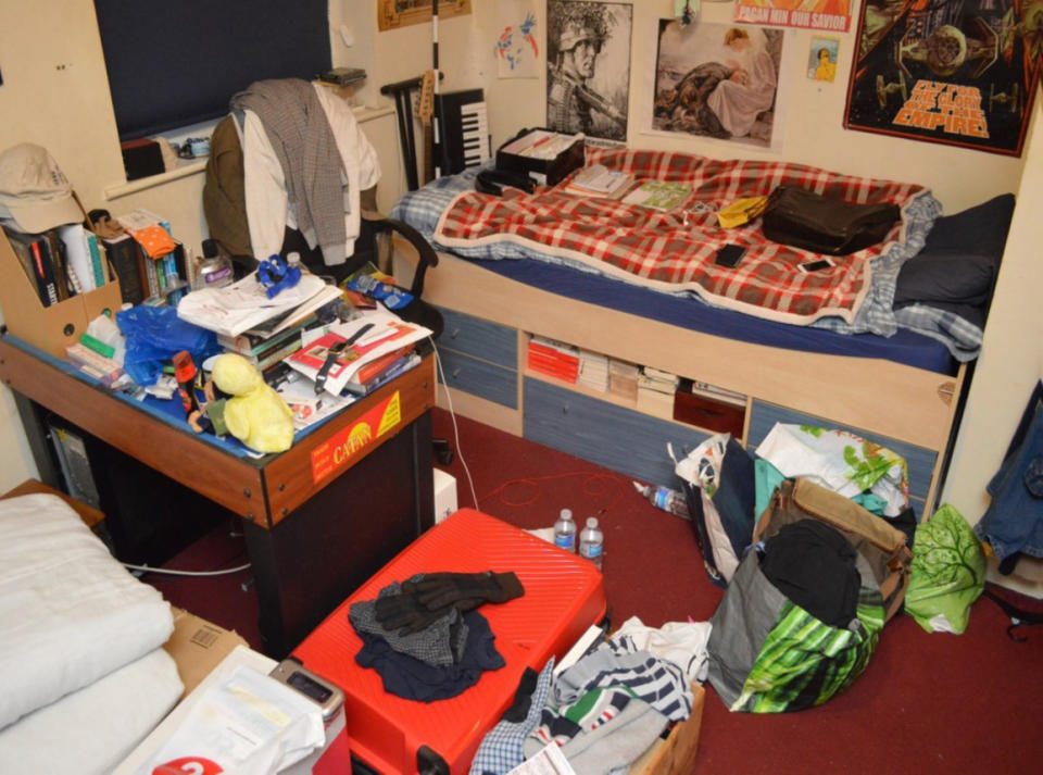 Hannam's cluttered bedroom where police stickers and badges belonging to the NA. (PA)