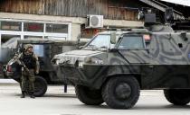 A Macedonian police armoured personnel carrier drives past premises in Kumanovo, north of the capital Skopje, Macedonia May 9, 2015. REUTERS/Ognen Teofilovski