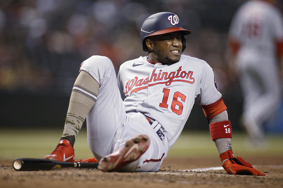 Washington Nationals' Victor Robles grimaces after being hit on the calf by a pitch from Arizona Diamondbacks' Caleb Smith during the fifth inning of a baseball game Friday, May 14, 2021, in Phoenix. (AP Photo/Darryl Webb)