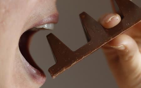 A woman poses with a 150g of Toblerone chocolate in Loughborough, Britain, November 8, 2016. REUTERS/Darren Staples