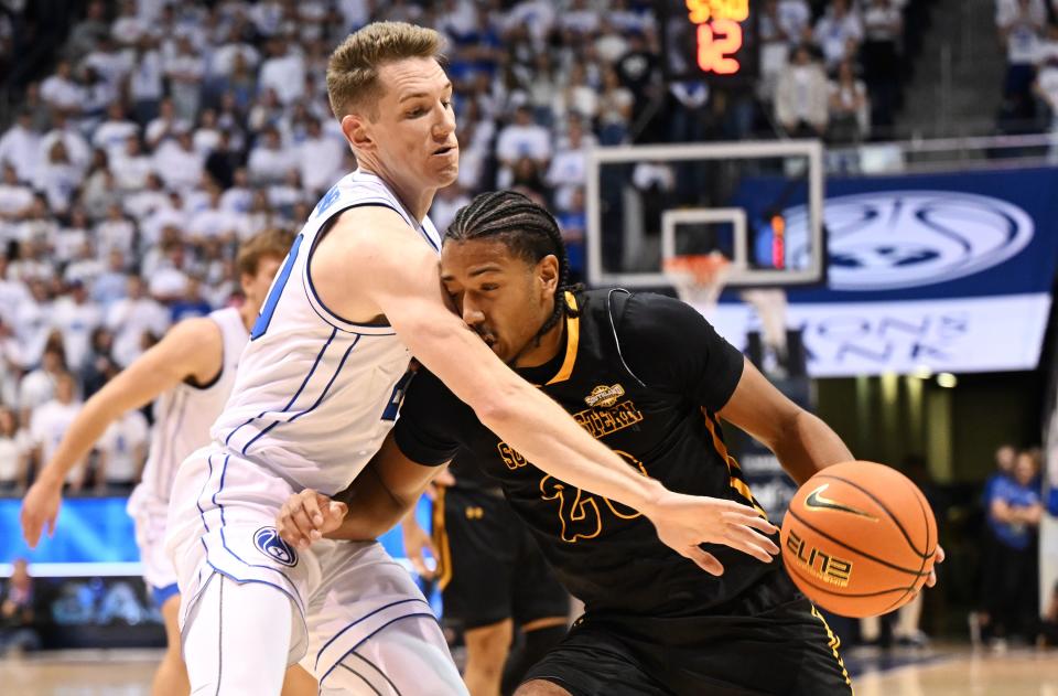 Brigham Young Cougars guard Spencer Johnson (20) defends Southeastern Louisiana Lions guard Alec Woodard (20) as BYU and SE Louisiana play at the Marriott Center in Provo on Wednesday, Nov. 15, 2023. | Scott G Winterton, Deseret News