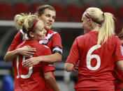 VANCOUVER, CANADA - JANUARY 19: Christine Sinclair #12 and Kaylyn Kyle #6 of Canada congratulate goal scorer Kelly Parker #15 of Canada during a 6-0 win over Haiti to open the 2012 CONCACAF Womenâ€™s Olympic Qualifying Tournament at BC Place on January 19, 2012 in Vancouver, British Columbia, Canada. (Photo by Jeff Vinnick/Getty Images)