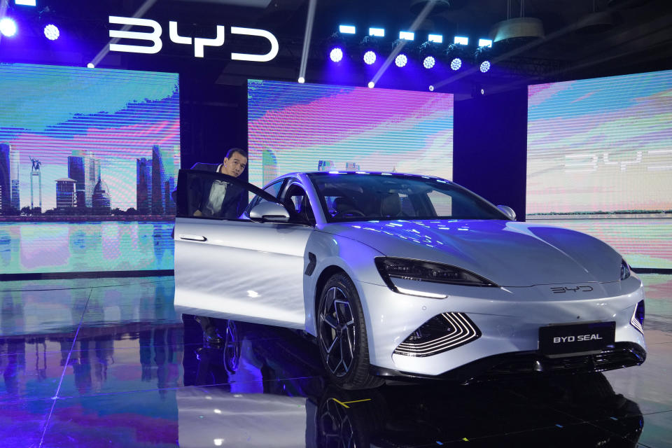 An attendee inspects a BYD Seal electric car during a launch event in Jakarta, Indonesia, Thursday, Jan. 18, 2024. China's top electric car maker BYD launched three electric passenger vehicles, Atto 3, Seal and Dolphin into the Indonesian market Thursday, bolstering its presence in Southeast Asia's largest economy. (AP Photo/Achmad Ibrahim)