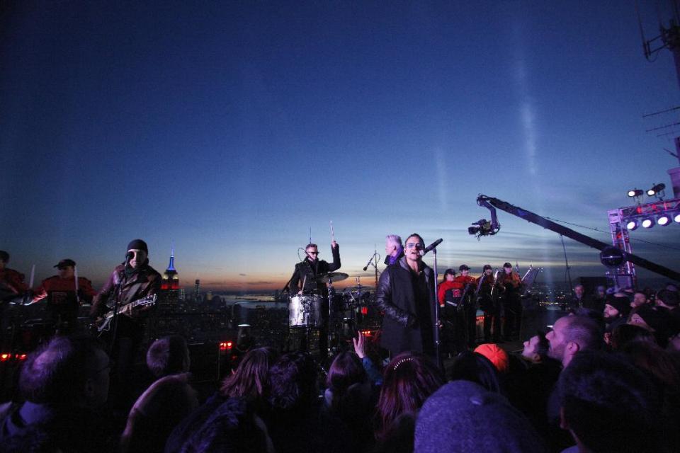 In this photo provided by NBC, U2 performs "Invisible," atop the G.E Building during "The Tonight Show" on Monday, Feb. 17, 2014, in New York. Jimmy Fallon made his debut Monday as the host of “The Tonight Show,” replacing Jay Leno after 22 years. (AP Photo/NBC, Lloyd Bishop)