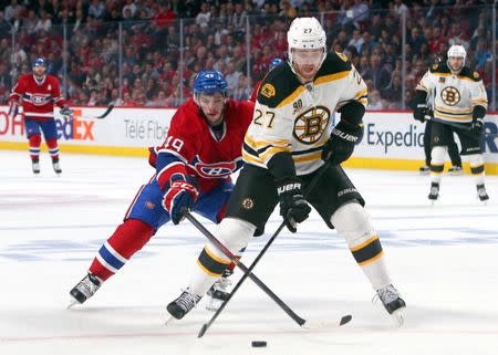 May 12, 2014; Montreal, Quebec, CAN; Montreal Canadiens left wing Michael Bournival (49) and Boston Bruins defenseman Dougie Hamilton (27) battle for the puck during the third period in the game six of the second round of the 2014 Stanley Cup Playoffs at Bell Centre. Mandatory Credit: Jean-Yves Ahern-USA TODAY Sports