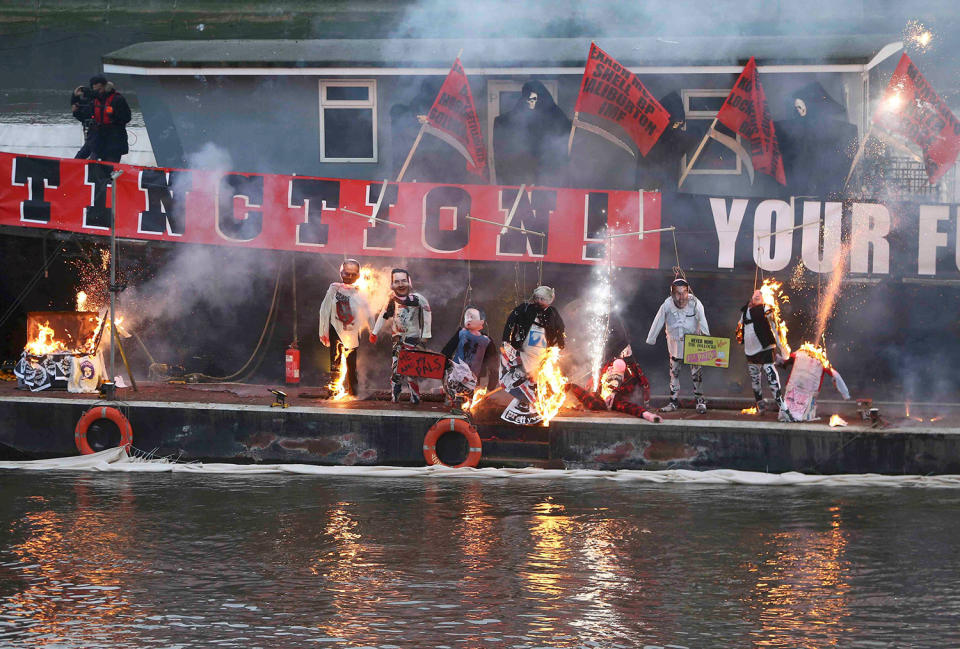 Punk memorabilia is burnt on a boat on the River Thames