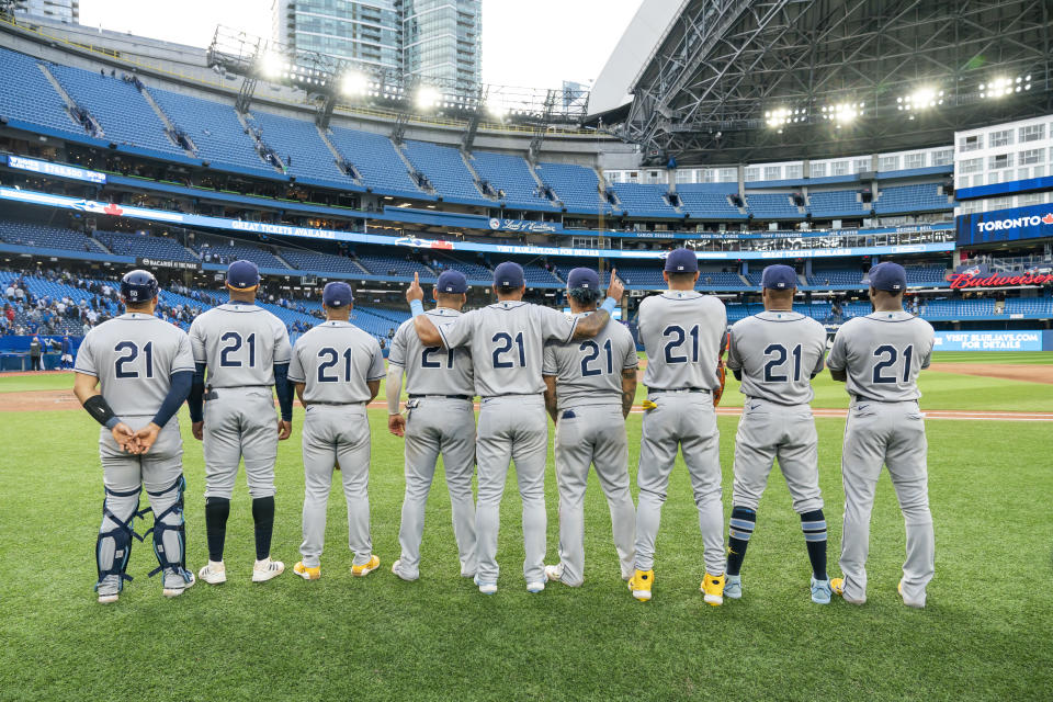 TORONTO, ON - SEPTEMBER 15: Rene Pinto #50, Yandy Diaz #2, Wander Franco #5, Isaac Paredes #17, David Peralta #6, Harold Ramirez #43, Jose Siri #22, Manuel Margot #13, and Randy Arozarena #56 of the Tampa Bay Rays pose after playing in the first all-Latino lineup in MLB history, while wearing the number 21 to honor Roberto Clemente day, following their win over the Toronto Blue Jays, at the Rogers Centre on September 15, 2022 in Toronto, Ontario, Canada. (Photo by Mark Blinch/Getty Images)