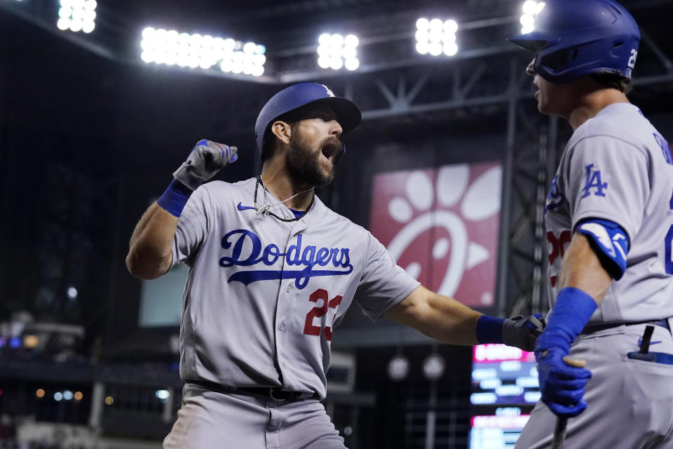 Los Angeles Dodgers' Steven Souza, left, celebrates his home run against the Arizona Diamondbacks with Andy Burns during the eighth inning of a baseball game Friday, June 18, 2021, in Phoenix. (AP Photo/Ross D. Franklin)