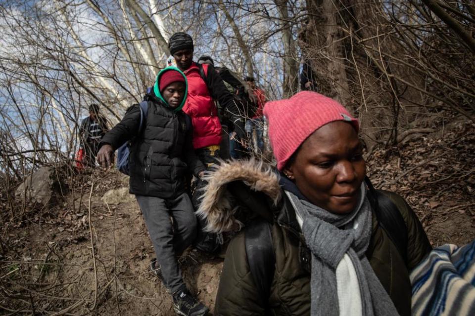 Refugees and migrants arrive at the shoreline to take a boat across the Evros River in an attempt to reach Greece from Turkey on 1 March 2020.