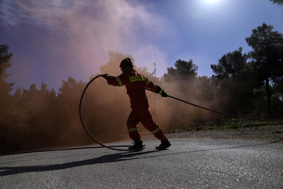 A firefighter takes part in a preparedness drill at Glyka Nera, in northeastern Athens on Thursday, April 4, 2024. Authorities have stepped up exercises ahead of the official start of the fire season on May 1. (AP Photo/Thanassis Stavrakis)