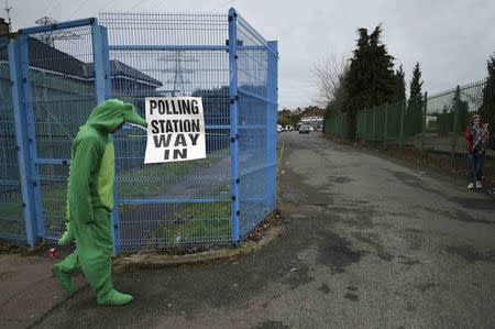 A man dressed as a Crocodile walks into a polling station in West Belfast, Northern Ireland March 2, 2017. REUTERS/Clodagh Kilcoyne