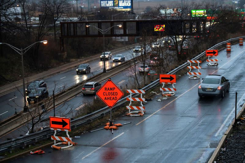 FILE PHOTO: Cars drive along the NJ 495 route while road work signs are seen on the roadside, in Union City