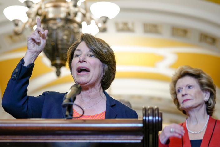 Sen. Amy Klobuchar, D-Minn., speaks as Sen. Debbie Stabenow, D-Mich., right, listens during a news conference after a policy luncheon Wednesday, May 31, 2023, on Capitol Hill in Washington.