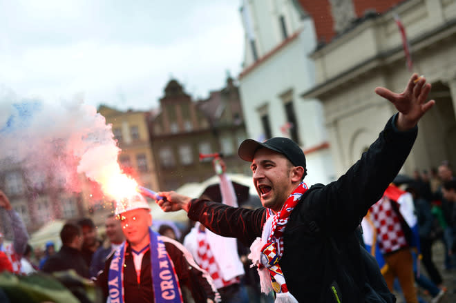 TOPSHOTS A Croatian fan lights a torch at the central square in Poznan on June 14, 2012, before their Euro 2012 football championships match against Italy. AFP PHOTO / DIMITAR DILKOFFDIMITAR DILKOFF/AFP/GettyImages